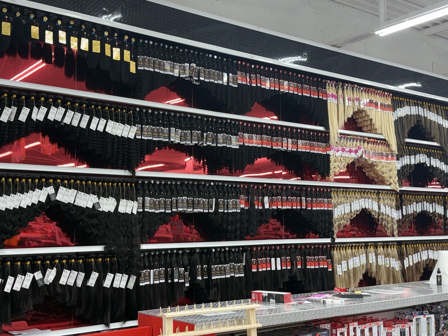 Human hair bundles and extensions displayed in Nashville beauty supply store